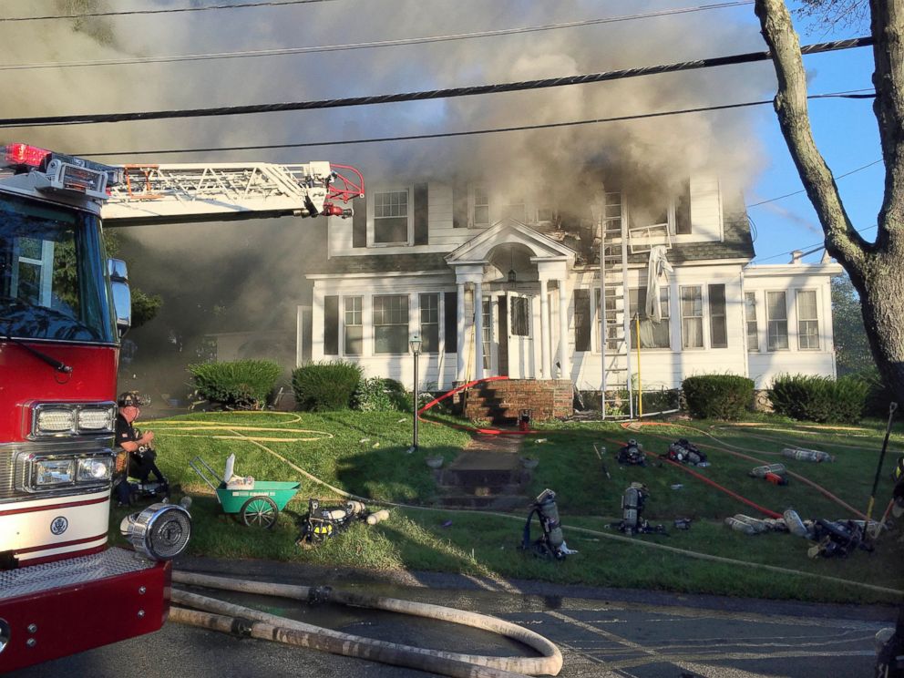 Firefighters battle a house fire, Thursday, Sept. 13, 2018, on Herrick Road in North Andover, Mass., one of multiple emergency crews responding to a series of gas explosions and fires triggered by a problem with a gas line that feeds homes in several