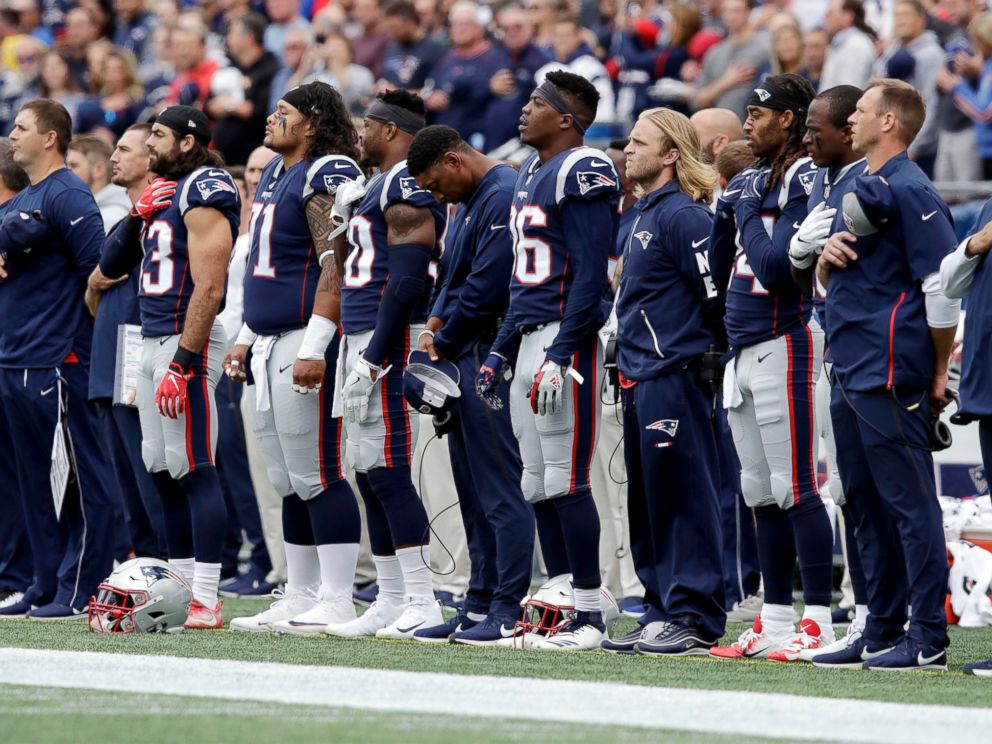 New England Patriots players stand during the national anthem before an NFL football game against the Houston Texans, Sunday, Sept. 9, 2018, in Foxborough, Mass. (AP Photo/Charles Krupa)