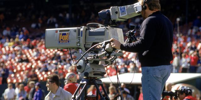 A FOX Sports television cameraman during a game between the Dallas Cowboys and the San Francisco 49ers at Candlestick Park on November 13, 1994 in San Francisco, Calif. 