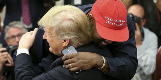 President Donald Trump hugs rapper Kanye West during a meeting in the Oval Office of the White House on October 11, 2018 in Washington, DC.