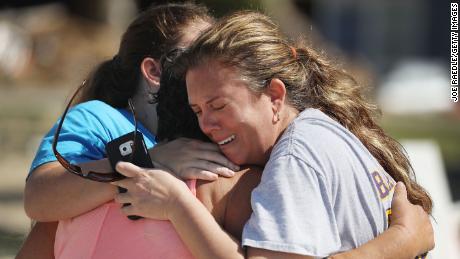 Elizabeth Hanson, right, and daughter Emaly hug their neighbor Cindy Clark in Mexico Beach.