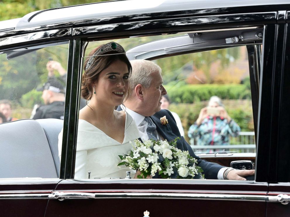 PHOTO: Princess Eugenie of York, left, arrives with her father Prince Andrew, Duke of York for her wedding with Jack Brooksbank in St Georges Chapel, Windsor Castle, England, Oct 12, 2018. 