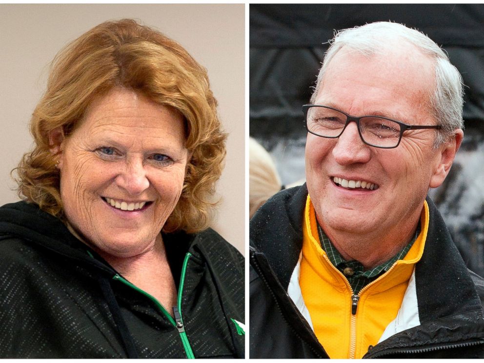 FILE - This combination of file photos shows North Dakota Senate candidates, Democratic Sen. Heidi Heitkamp, left, during a campaign stop in Grand Forks, and her Republican challenger Kevin Cramer at a campaign stop in Fargo. (AP Photo/Bruce Crummy, File)
