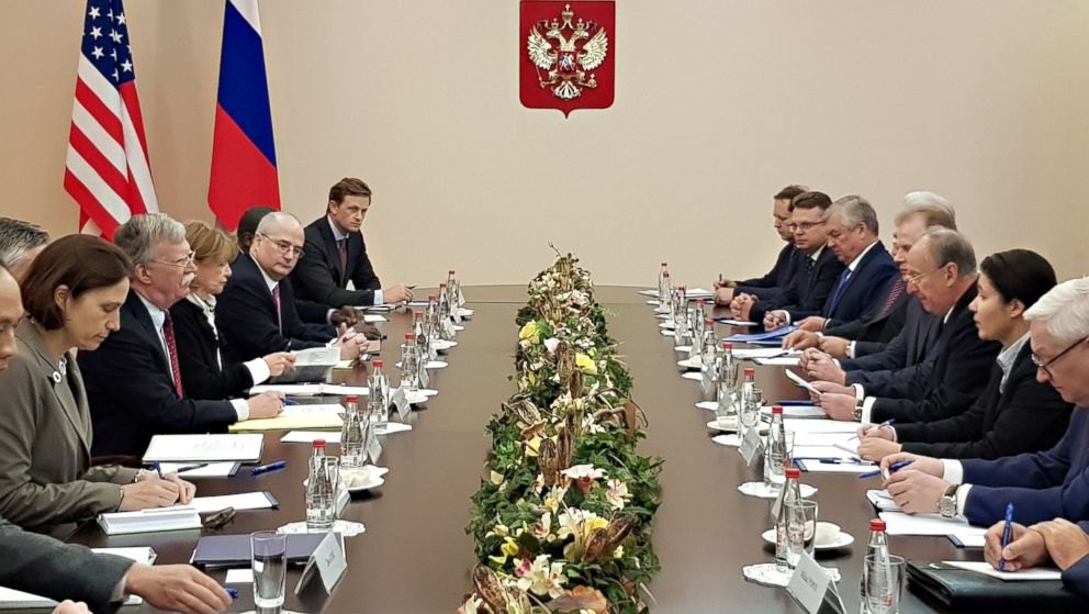 A handout photo from the Russian Security Council press service shows Russian Security Council Secretary Nikolai Patrushev, 3rd from right, speaking with US National Security Adviser John Bolton, 4th from left, during their meeting in Moscow, Oct. 2018. 