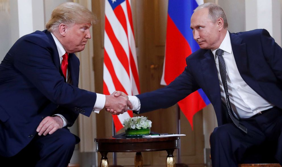 PHOTO: In this July 16, 2018, file photo, U.S. President Donald Trump, left, and Russian President Vladimir Putin shake hands at the beginning of a meeting at the Presidential Palace in Helsinki, Finland.