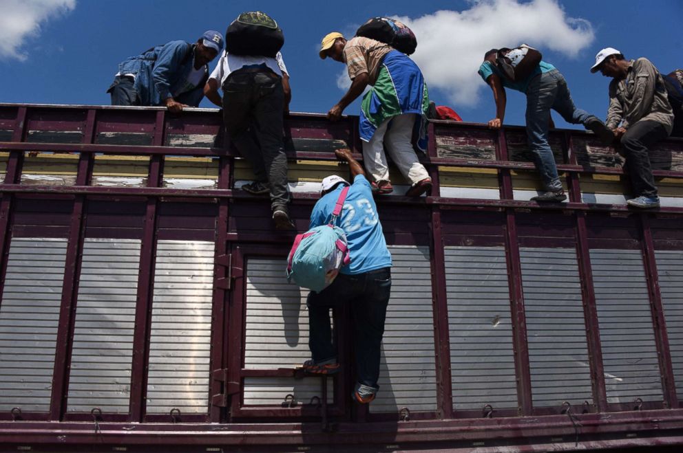 PHOTO: Honduran migrants heading in a caravan to the U.S., climb on a truck in Tapachula, Chiapas state, Mexico, Oct. 22, 2018.