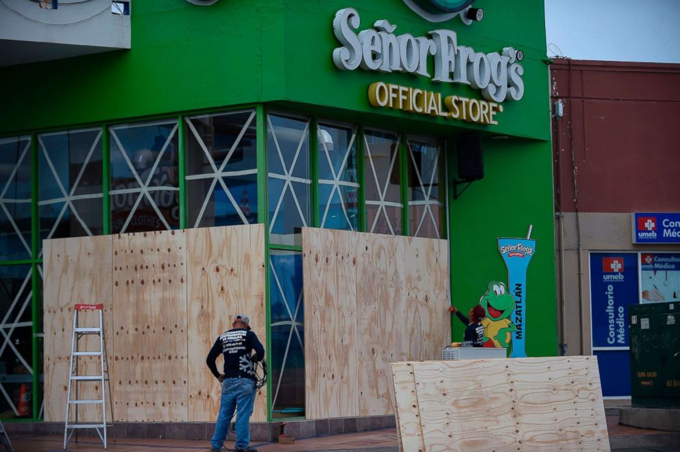 PHOTO: Workers protect a storefront with wood panels at the Mazatlan port in Sinaloa, Mexico, on Oct. 22, 2018, before the arrival of Hurricane Willa.