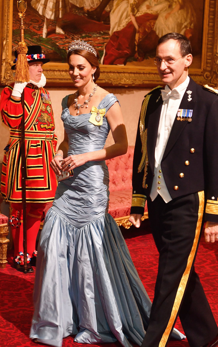 Catherine, Duchess of Cambridge, walks with Rear Admiral Ludger Brummelaar (R) as they attend a state banquet in honor of Kin