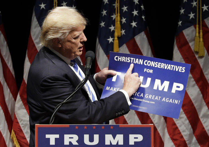 Then-presidential candidate Donald Trump holds up a "Christian Conservatives for Trump" sign at a rally on Sept. 28, 2016, in