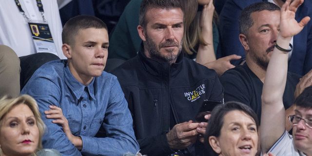 Former England footballer David Beckham and his son Romeo watch the wheelchair basketball final at The Invictus Games in Sydney, Australia, Saturday, Oct. 27, 2018. Prince Harry and his wife Meghan are on day twelve of their 16-day tour of Australia and the South Pacific. (AP Photo)