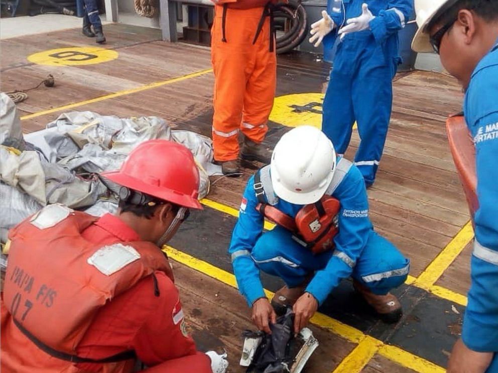 In this photo released by Indonesian Disaster Mitigation Agency (BNPB) rescuers inspect debris believed to be from a Lion Air passenger jet that crashed off West Java on Monday, Oct. 29, 2018. A Lion Air flight crashed into the sea just minutes after