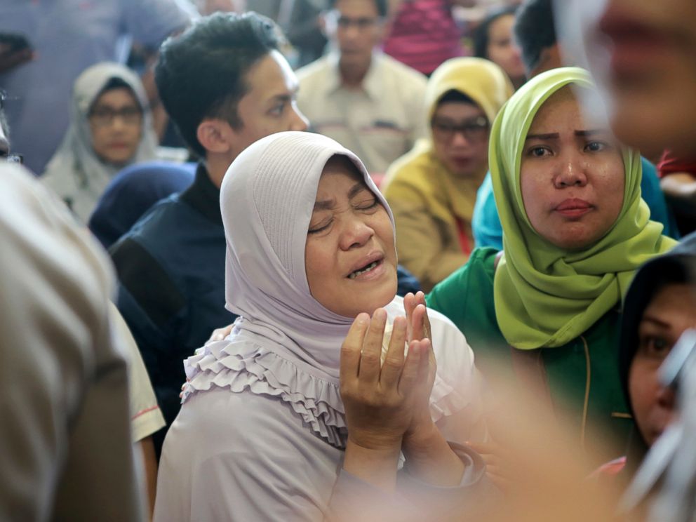 A relative of passengers prays as she and others wait for news on a Lion Air plane that crashed off Java Island at Depati Amir Airport in Pangkal Pinang, Indonesia Monday, Oct. 29, 2018. Indonesia disaster agency says that the Lion Air Boeing 737-800