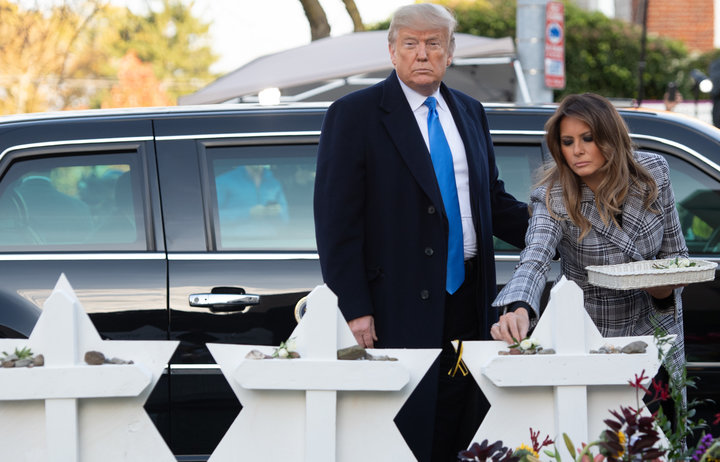 President Trump and first lady Melania Trump&nbsp;lay flowers on 11 makeshift Star of David memorials erected outside the syn