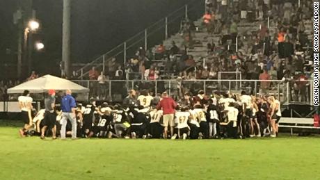 Players and coaches from both teams knelt in prayer after Dylan Thomas was taken to the hospital.