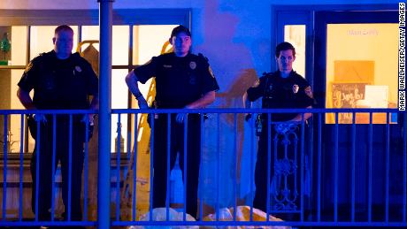 Police officers are stationed outside Hot Yoga Tallahassee on Friday night after the shooting.