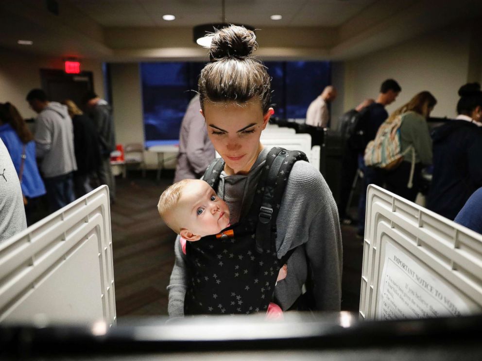 PHOTO: Kristen Leach votes with her daughter, Nora, on election day in Atlanta, Nov. 6, 2018.