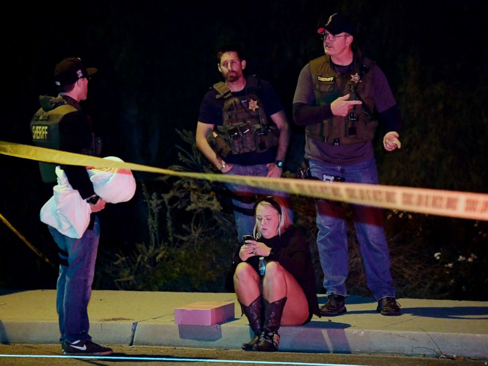 PHOTO: Sheriffs deputies speak to a potential witness as they stand near the scene where a gunman opened fire, Nov. 8, 2018, in Thousand Oaks, Calif.