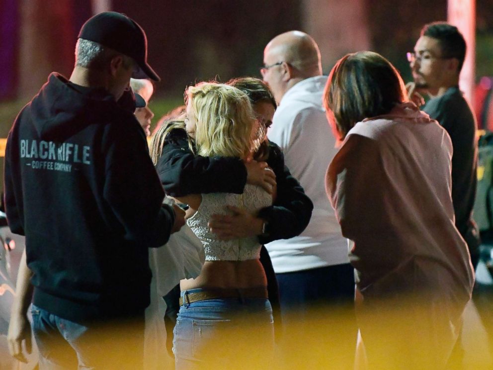 PHOTO: People comfort each other as they stand near the scene, Nov. 8, 2018, in Thousand Oaks, Calif., where a gunman opened fire Wednesday inside a country dance bar crowded with hundreds of people on college night.