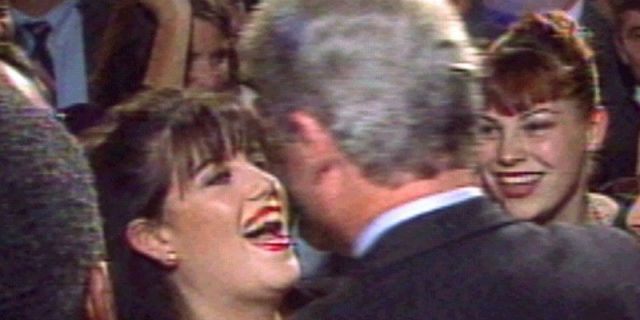 President Clinton greets Monica Lewinsky (L) at a Washington fundraising event in October 1996.