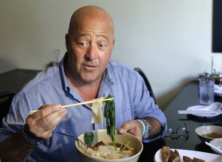 Andrew Zimmern samples Taiwanese noodle soup and pork roll at Happy Stony Noodle in Elmhurst, Queens, in New York.