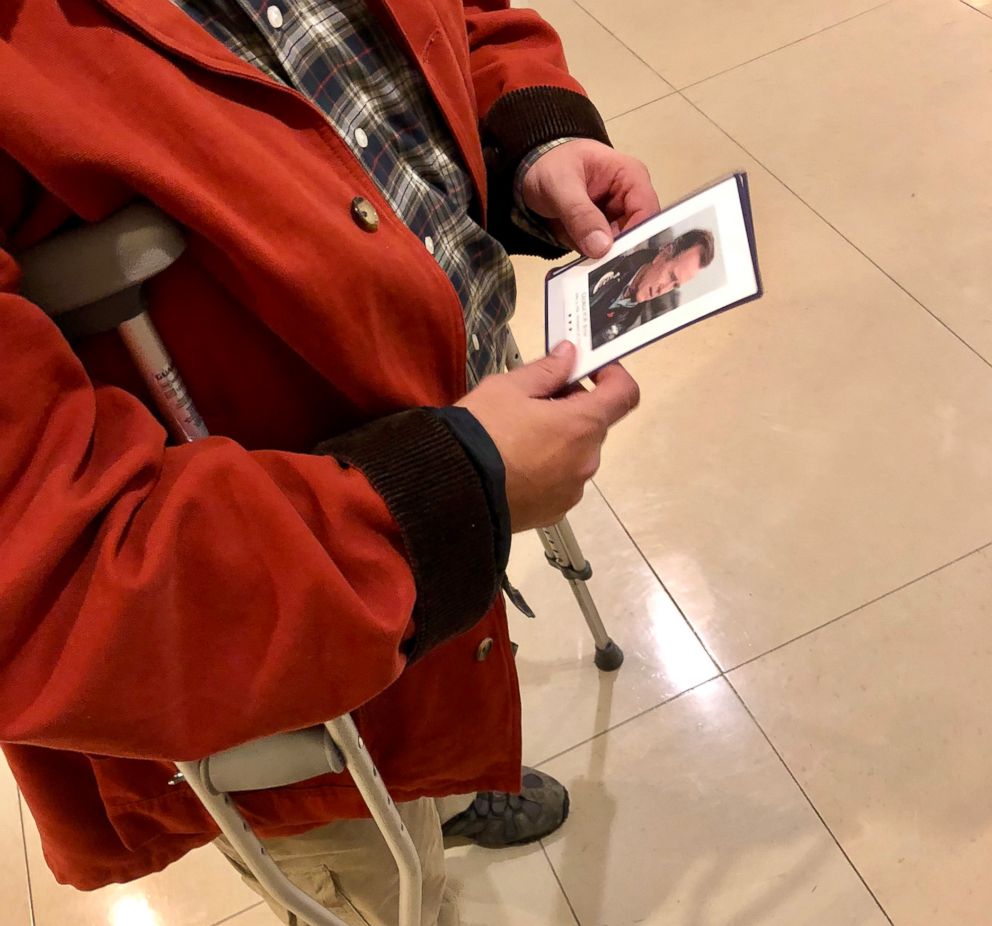 PHOTO: Paul Smith, 52, of Tooele, Utah, holds a remembrance card with a photo of President George H.W. Bush on Dec. 4, 2018. Smith flew in on a red-eye from Salt Lake City to see the former presidents casket in the U.S. Capitol.