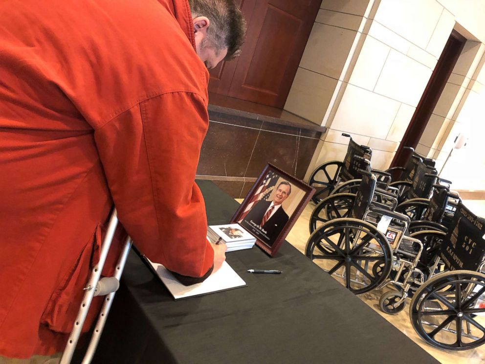 PHOTO: Paul Smith, 52, of Tooele, Utah, signs a condolence book with a message for former President George H.W. Bush and his family as he leaves the U.S. Capitol, where Bush lies in state before his funeral service on Dec. 4, 2018.