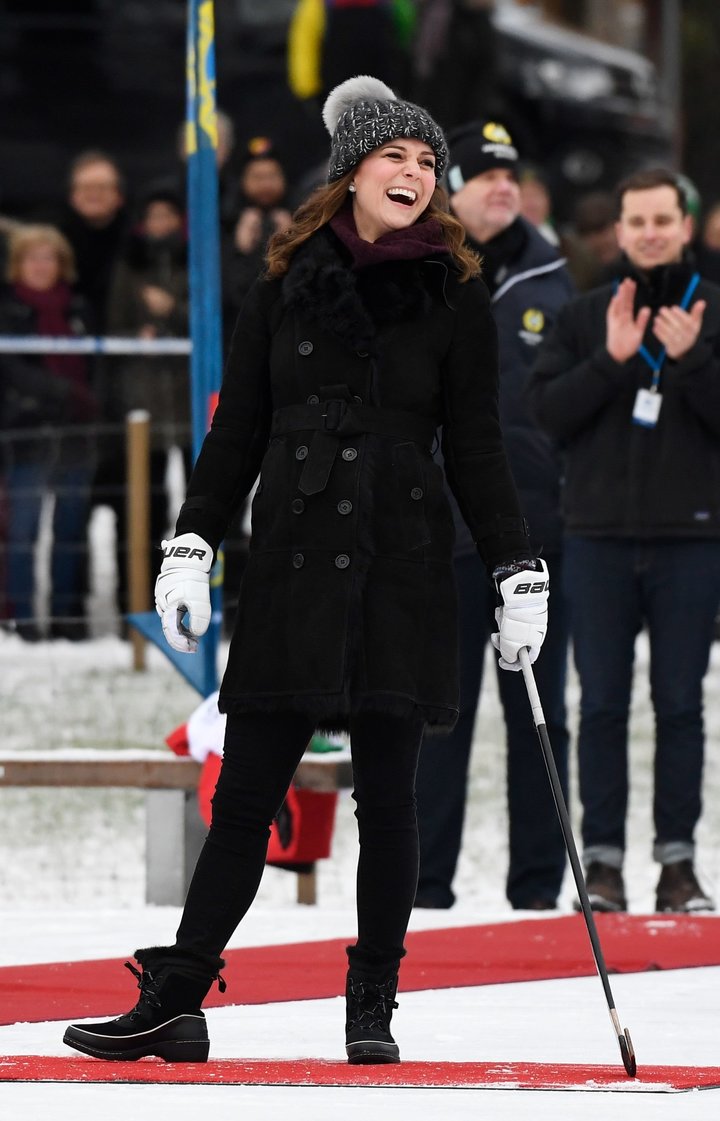 The Duchess of Cambridge laughs as she tries out the game of bandy during a meeting with a group of local bandy players on th