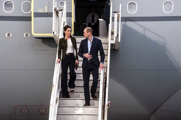 The Duke and Duchess of Cambridge descend from their airplane as they arrive at RAF Akrotiri to celebrate the upcoming Christ