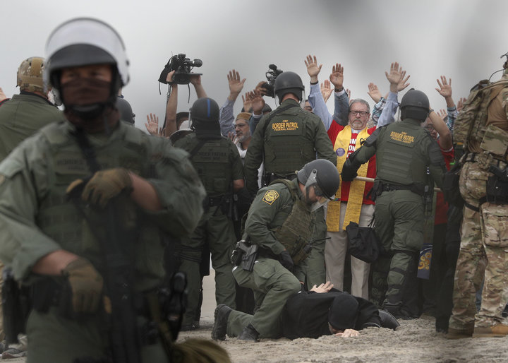 U.S. Border Patrol agents make arrests during a pro-migration protest by members of various faith groups.