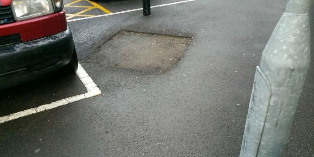 The square hole in the tarmac outside Gloucestershire Royal Hospital where a tree had previously grown and where Audrey Worrall reportedly fell out of her wheelchair.