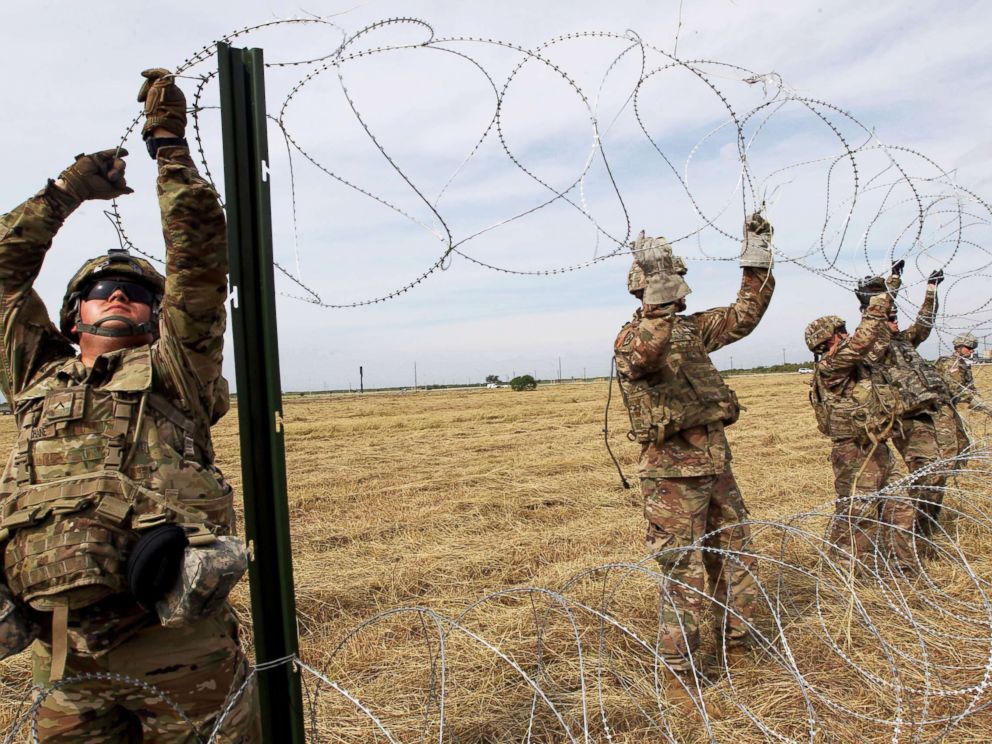 PHOTO: Army soldiers from Ft. Riley, Kansas, put up razor wire fence for an encampment to be used by the military near the U.S. Mexico border in Donna, Texas, Nov. 4, 2018.