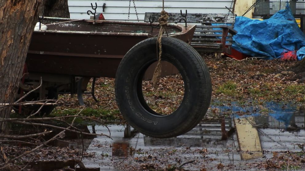 PHOTO: A tire swing sits outside of a burned house after three children died and a mother and two siblings escaped a fire in Tell City, Ind., Dec. 28, 2018.