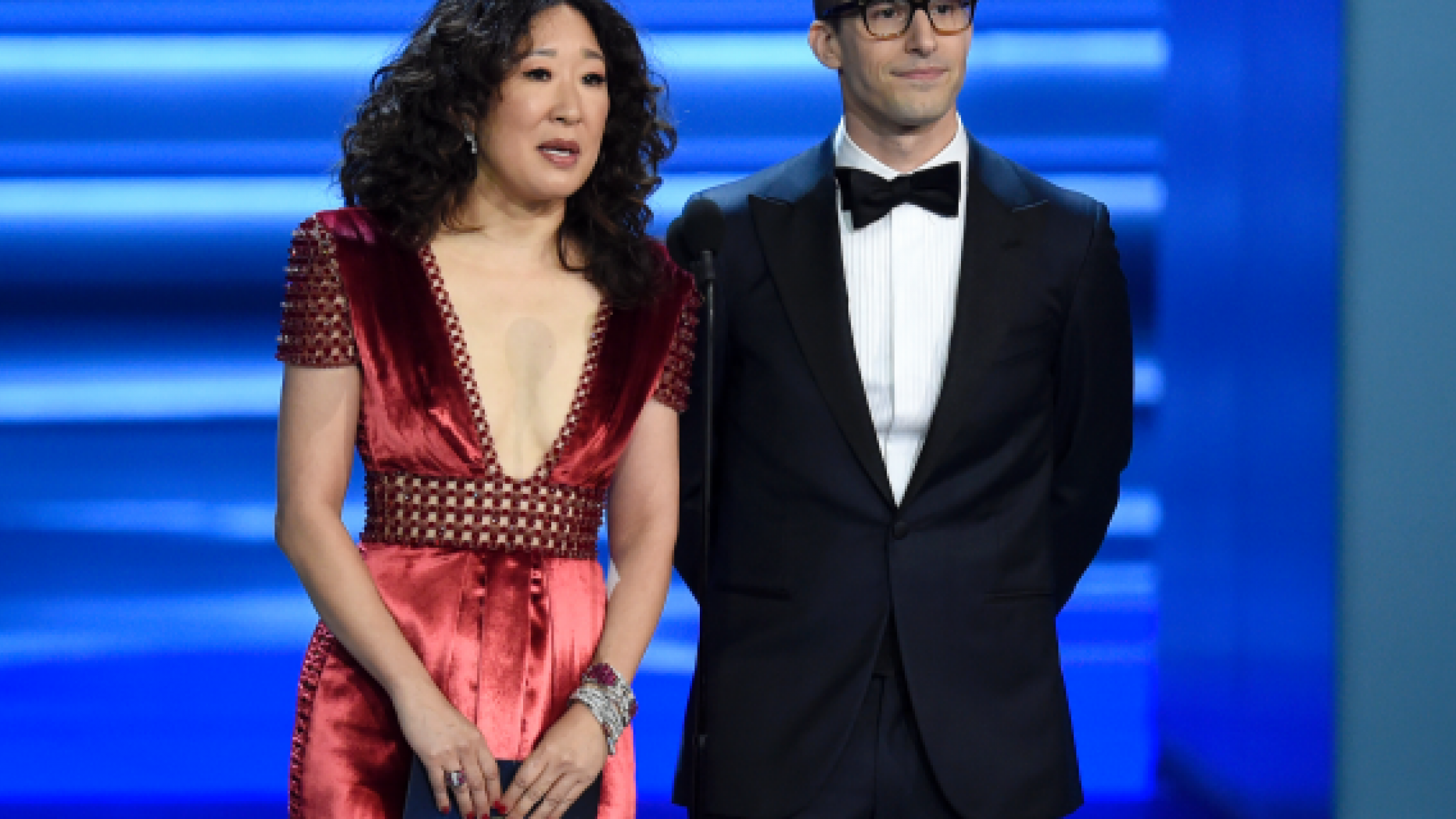 Sandra Oh, left, and Andy Samberg present an award at the 70th Primetime Emmy Awards in Los Angeles. Oh and Samberg will share host duties at next month’s Golden Globe ceremony. 