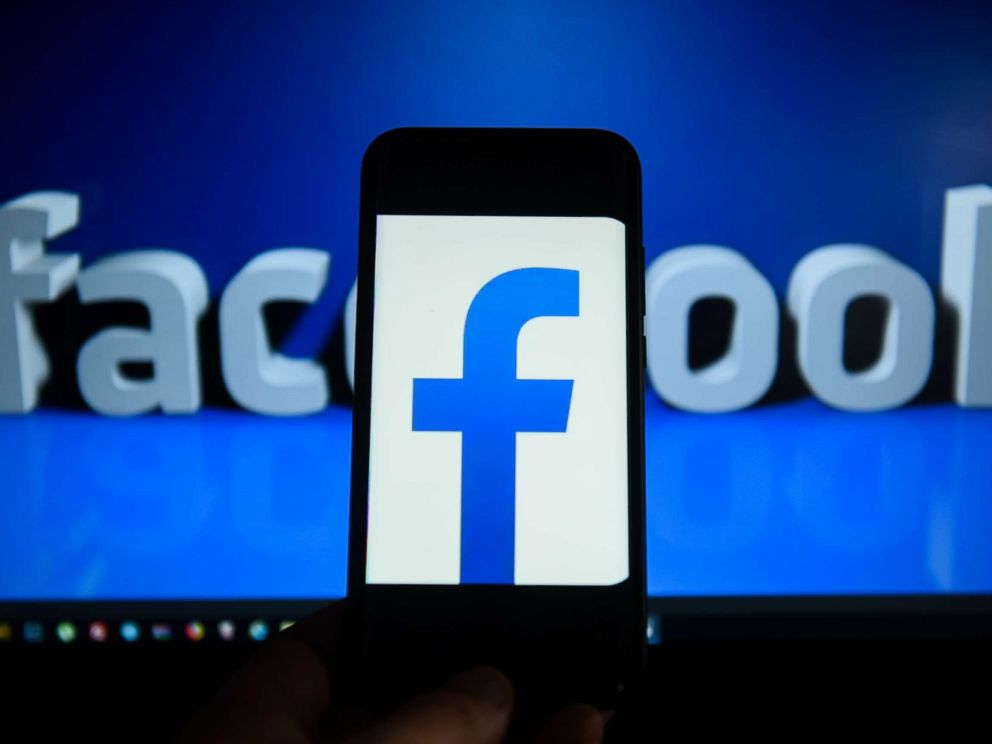 PHOTO: Facebook logo is seen on an android mobile phone in front of a computer screen. 