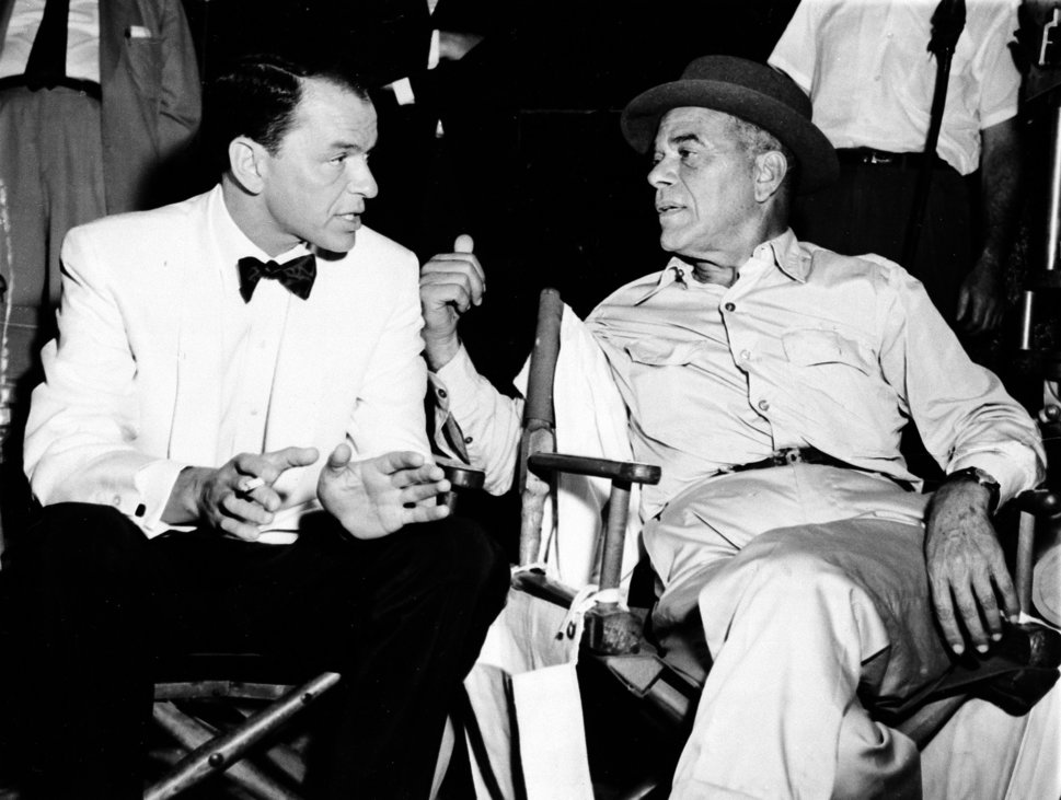 Frank Capra, right, talks with Frank Sinatra on a movie set in Hollywood on Dec. 12, 1958.