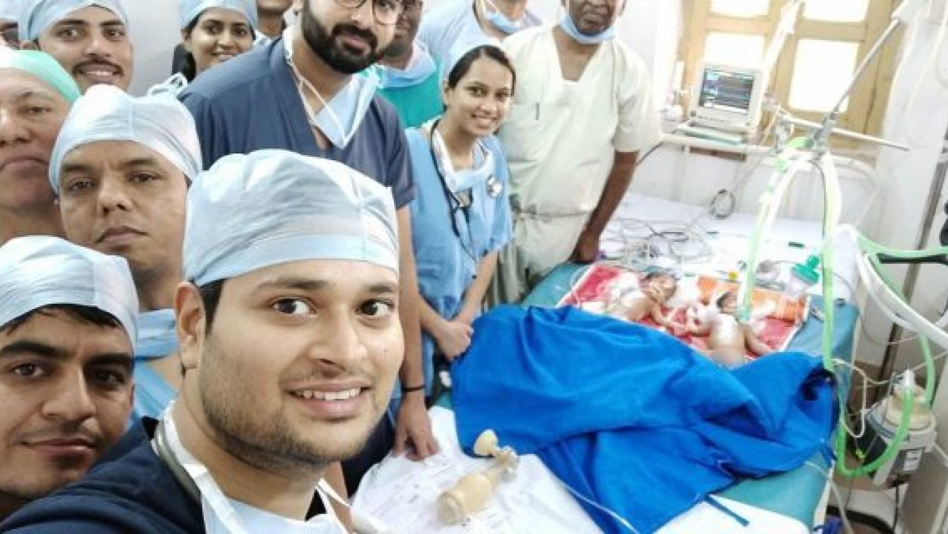 The team of gifted surgeons, pictured moments after successfully separating the twins, performed the lifesaving operation free of charge. 