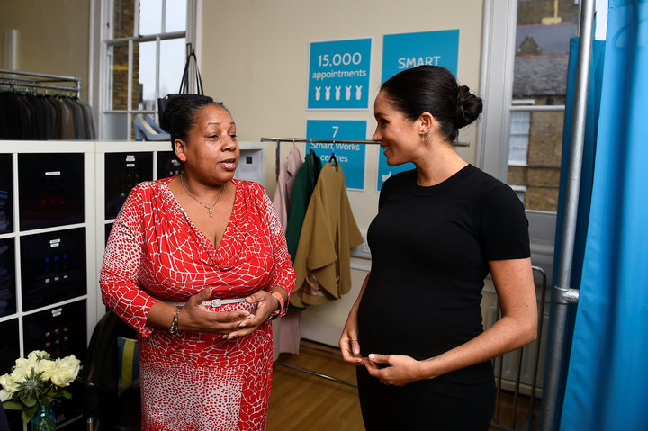 The Duchess of Sussex chats with Patsy Wardally as they pick out clothes.&nbsp;
