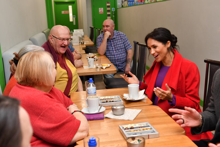 The Duchess of Sussex speaks with local people at Number 7, a "Feeding Birkenhead" citizens supermarket and community cafe, a