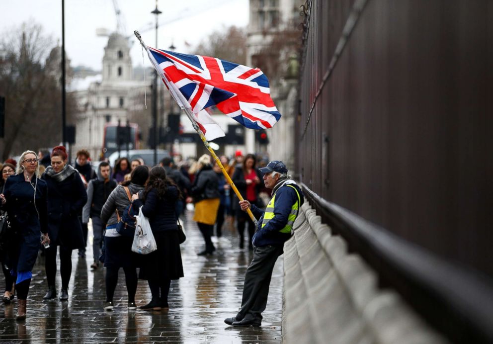 PHOTO: People walk past a pro-Brexit protester outside the Houses of Parliament, after Prime Minister Theresa Mays Brexit deal was rejected in London, Jan. 16, 2019.
