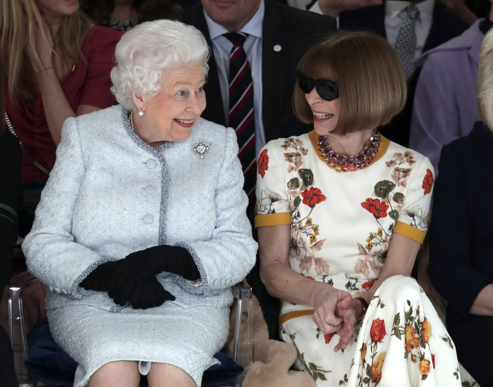 Queen Elizabeth sits next to Anna Wintour as they view Richard Quinn's runway show on Feb. 20, 2018.