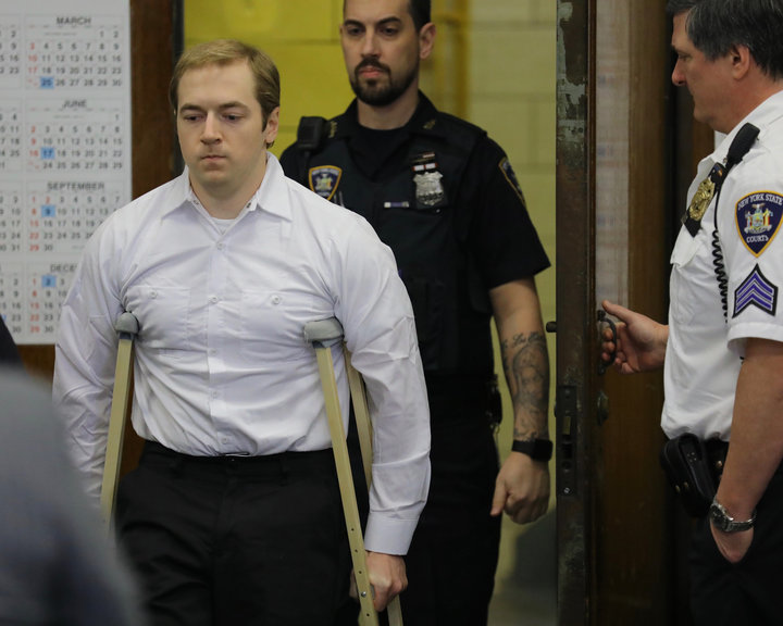 James Jackson, using crutches, is escorted into criminal court, Wednesday Jan. 23, 2019 in New York. Jackson, a white suprema