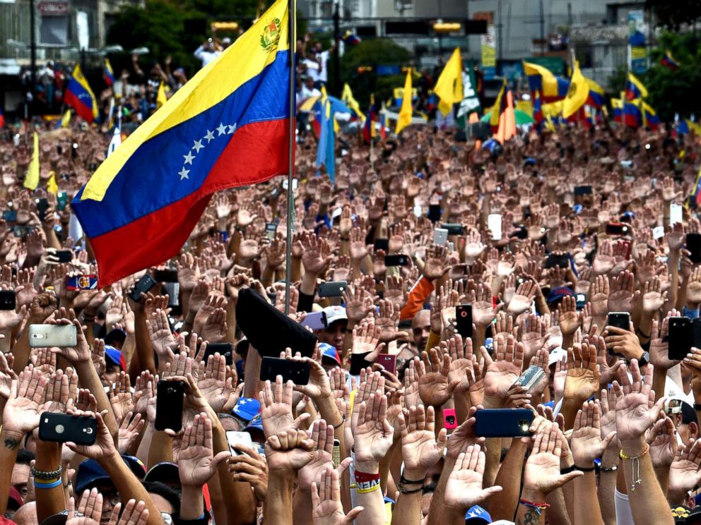 PHOTO: People raise their hands during a mass opposition rally against President Nicolas Maduro in in Caracas, Venezuela, Jan. 23, 2019. 