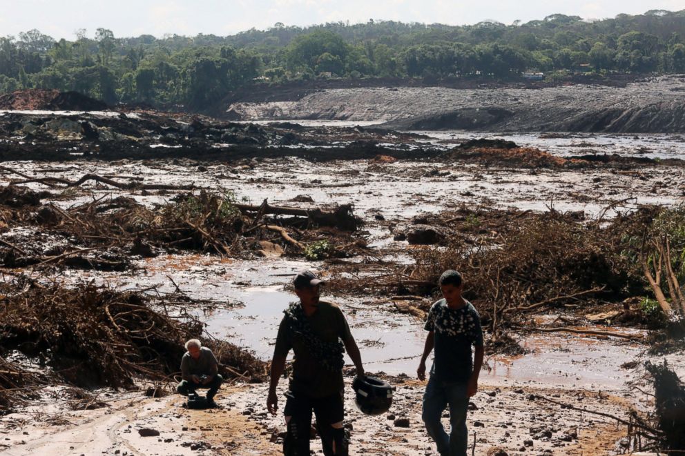 PHOTO: Men walk near damage caused by the breakage of a dam containing mineral waste from Vale, the worlds largest iron producer, in Brumadinho, municipality of Minas Gerais, Brazil, Jan. 25, 2019.