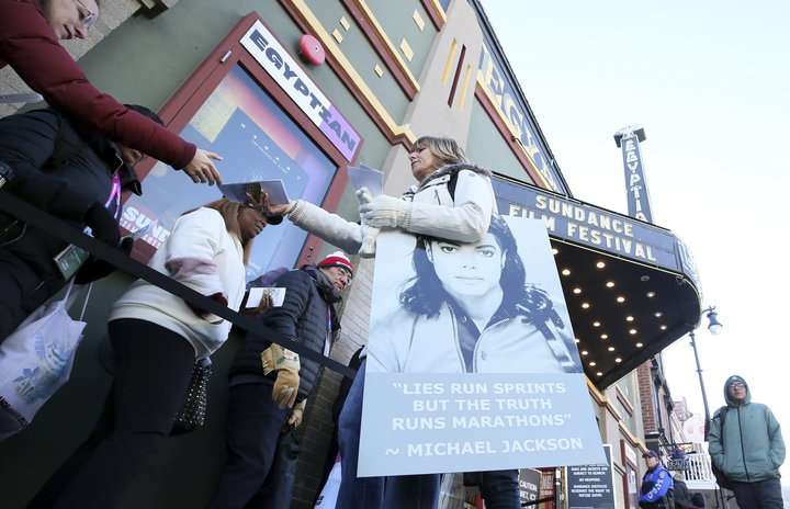 A protester hands out pamphlets to attendees at the documentary's premiere Friday at the Sundance Film Festival.