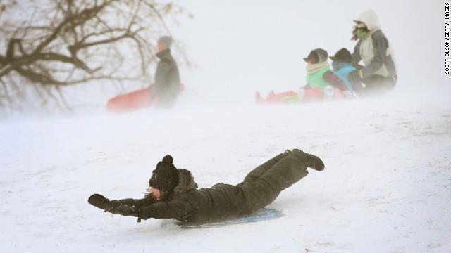 A child slides down a hill on a sled in Chicago&#39;s Humboldt Park in January 2014.