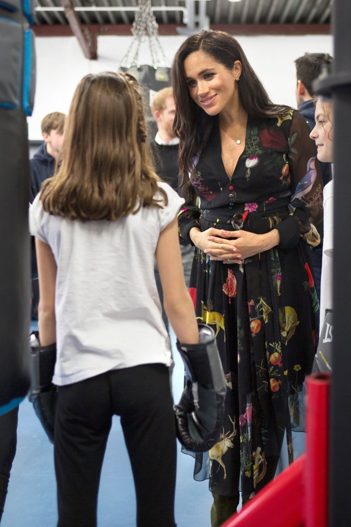 Meghan talks with a young boxer at Empire Fighting Chance, which helps at-risk youths.