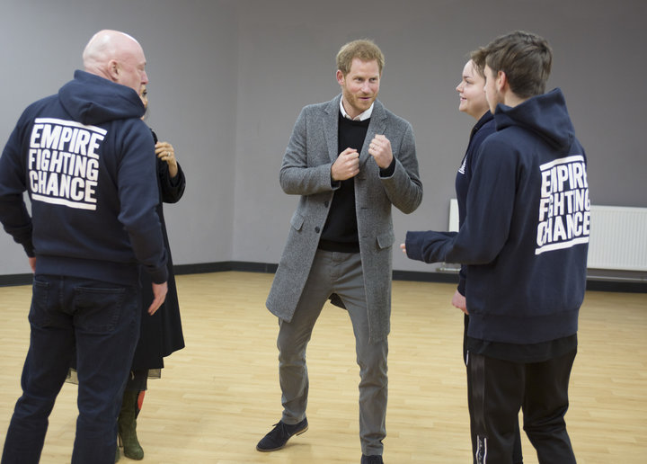Harry chats with Lestyn Jones and Sarah Lucey during a visit to the boxing charity Empire Fighting Chance in Bristol.