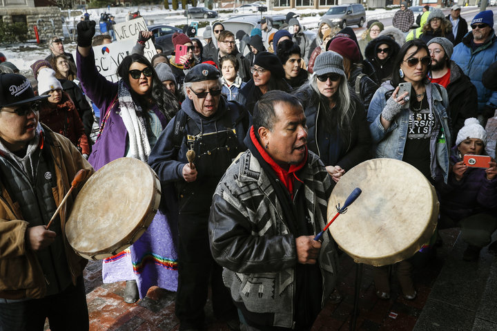 A protester leads a Native American prayer with a traditional drum outside the Catholic Diocese of Covington, Kentucky, on Ja