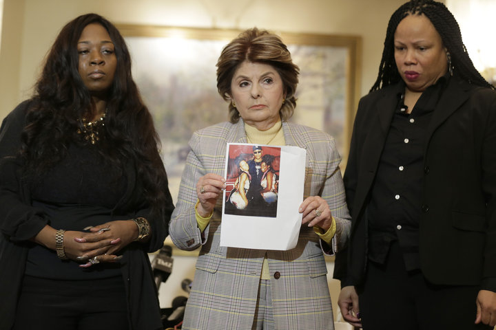 Latresa Scaff (R) and Rochelle Washington (L) look on as attorney Gloria Allred holds up a picture of them as teenagers on th