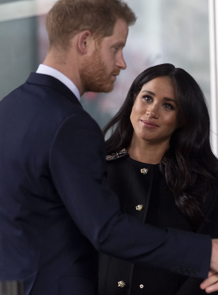 Meghan looks up at Harry during the stop on Tuesday.